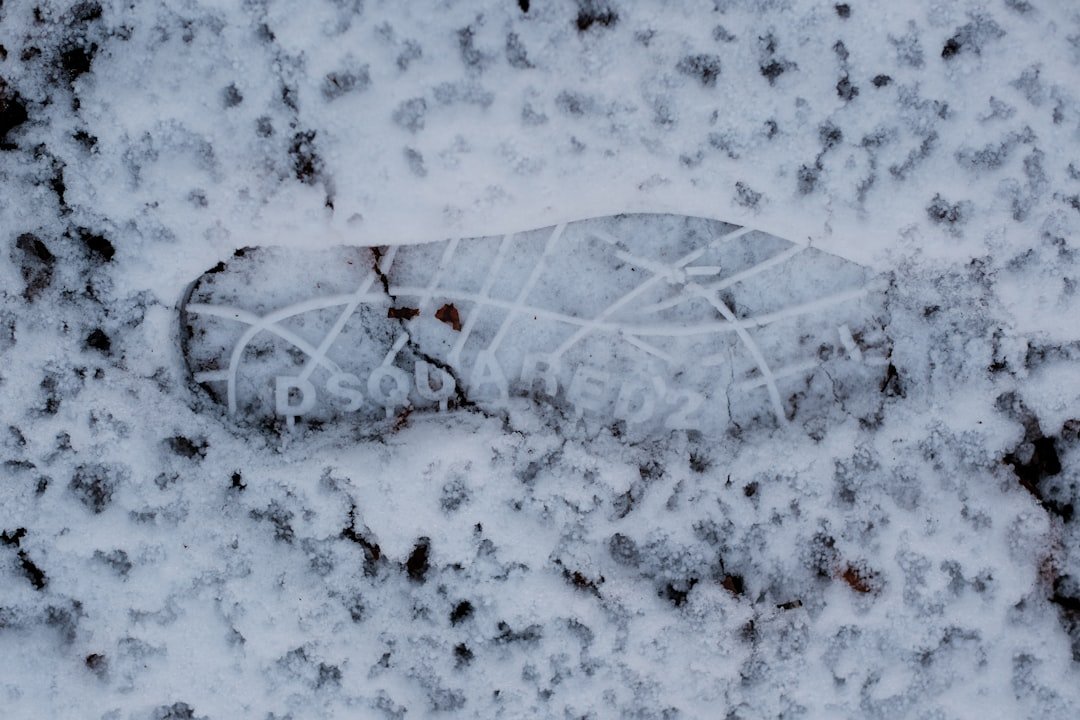 Fresh tattoo on forearm during winter season with snow visible through window